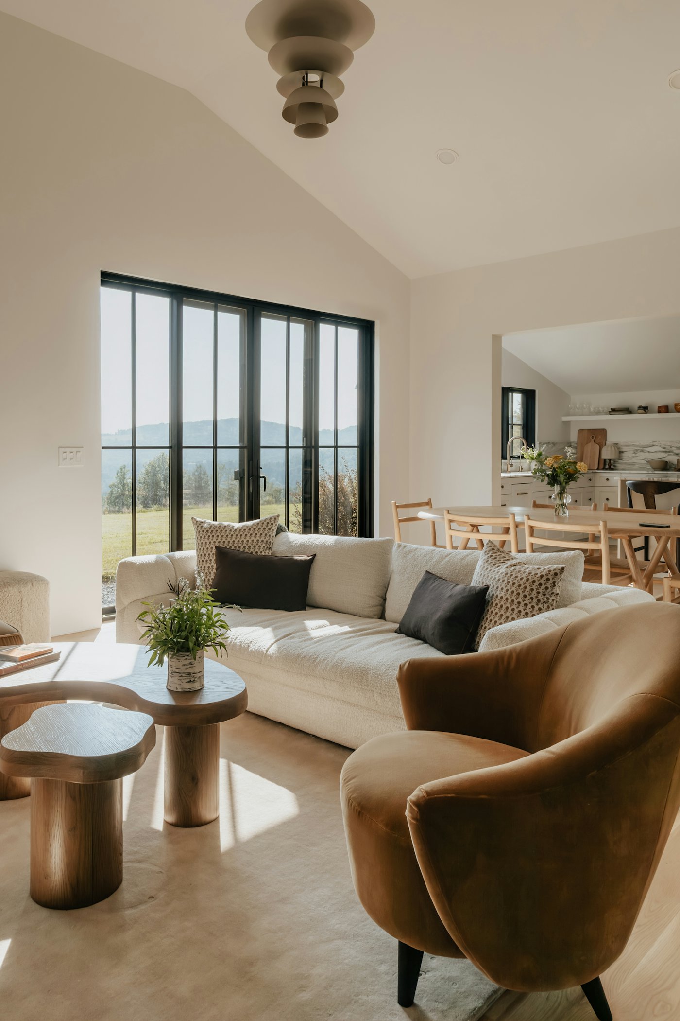 Warm daylight across a living room with a linen sofa.